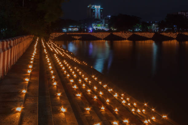 Home thousands of oil lamps being lit on the steps of a temple pond, photographed in low light condition with selective focus on foreground adds beauty to frame Kapaleeshwarar Temple mylapore chennai india